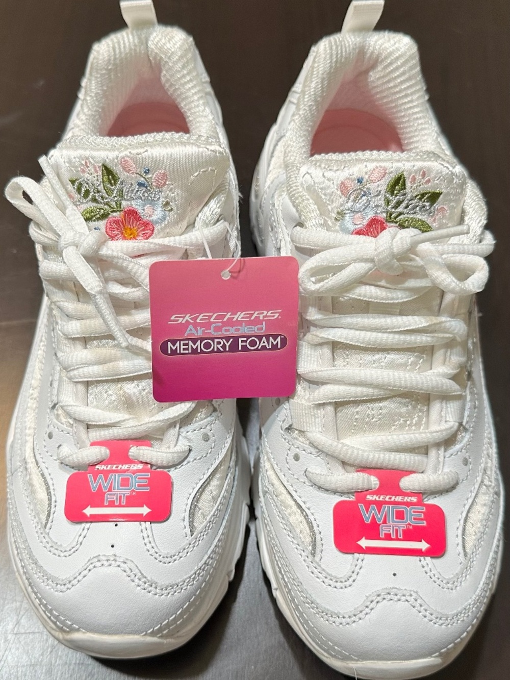 These are Skechers Women's D'Lites - Bright Blossoms walking sneakers, which fea